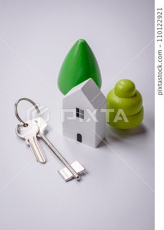 A small wooden house and keys as an idea for investing in your own home 110122921