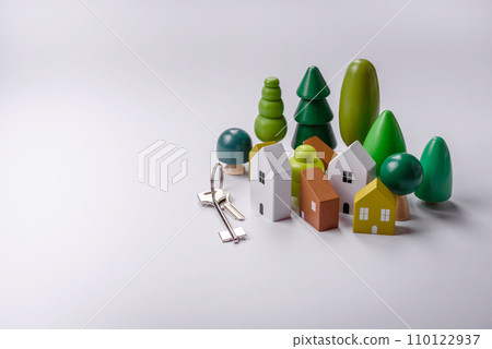 A small wooden house and keys as an idea for investing in your own home 110122937