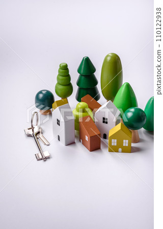 A small wooden house and keys as an idea for investing in your own home 110122938