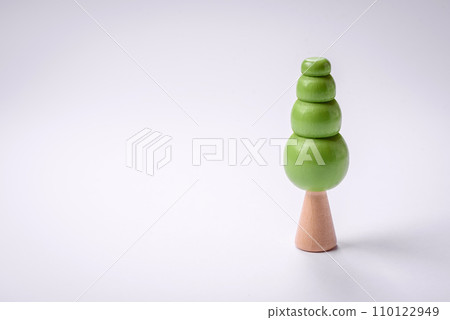 Wooden model of a tree with a green crown and trunk on a white background 110122949
