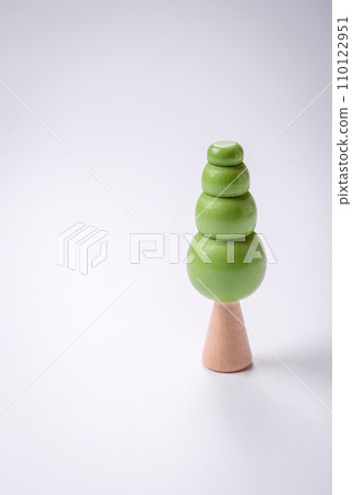 Wooden model of a tree with a green crown and trunk on a white background Wooden model of a tree with a green crown and trunk on a white background 110122951