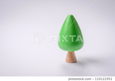 Wooden model of a tree with a green crown and trunk on a white background 110122952