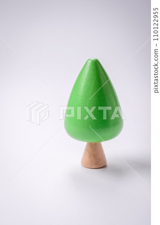 Wooden model of a tree with a green crown and trunk on a white background 110122955