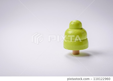 Wooden model of a tree with a green crown and trunk on a white background 110122960