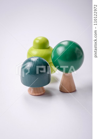 Wooden model of a tree with a green crown and trunk on a white background 110122972