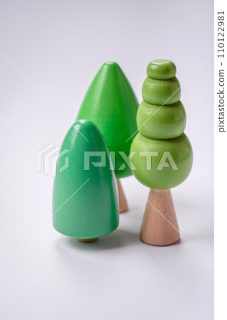 Wooden model of a tree with a green crown and trunk on a white background 110122981