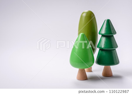 Wooden model of a tree with a green crown and trunk on a white background Wooden model of a tree with a green crown and trunk on a white background 110122987
