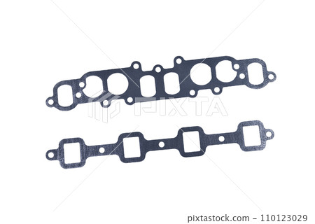 gasket set of automotive paronite exhaust and intake manifold with metal inserts and auto parts on a white background gasket set of automotive paronite exhaust and intake manifold with metal inserts and auto parts on a white background 110123029