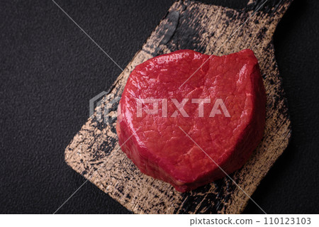 Fresh juicy raw filet mignon with salt, spices and herbs 110123103
