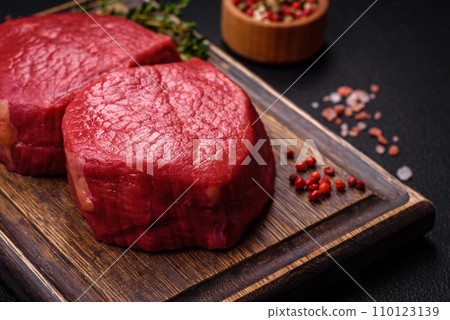 Fresh juicy raw filet mignon with salt, spices and herbs 110123139