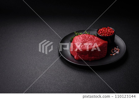 Fresh juicy raw filet mignon with salt, spices and herbs Fresh juicy raw filet mignon with salt, spices and herbs 110123144