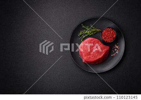 Fresh juicy raw filet mignon with salt, spices and herbs Fresh juicy raw filet mignon with salt, spices and herbs 110123145