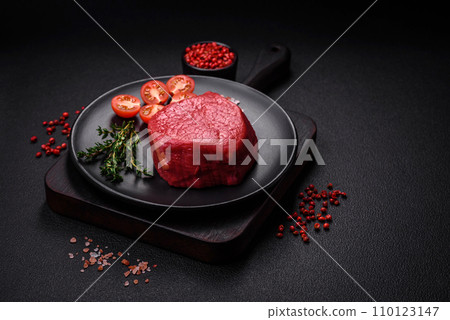 Fresh juicy raw filet mignon with salt, spices and herbs 110123147
