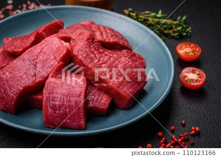 Juicy fresh raw beef meat with salt, spices and herbs Juicy fresh raw beef meat with salt, spices and herbs 110123166