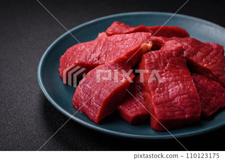 Juicy fresh raw beef meat with salt, spices and herbs 110123175