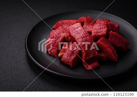 Juicy fresh raw beef meat with salt, spices and herbs 110123190
