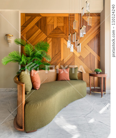 Green Couch in a Modern Living Room with Wooden Wall and Chandelier Green Couch in a Modern Living Room with Wooden Wall and Chandelier 110124240