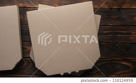 Pizza closed carton box on natural dark wooden table flat lay mockup with blank space 110124959
