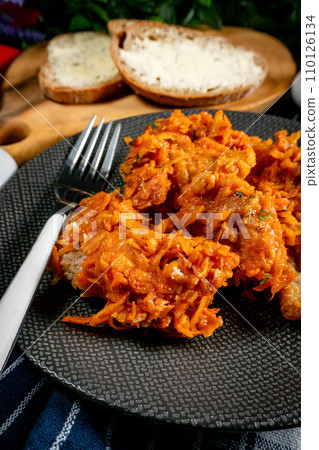 Fish in Greek kind with vegetables and tomato sauce. 110126134