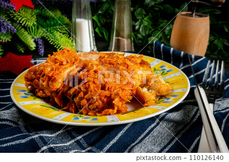Fish in Greek kind with vegetables and tomato sauce. Fish in Greek kind with vegetables and tomato sauce. 110126140