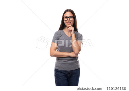 young pretty brunette woman in a gray t-shirt and glasses on a white background with copy space young pretty brunette woman in a gray t-shirt and glasses on a white background with copy space 110126188