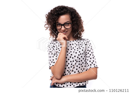 young positive caucasian businesswoman with curly black hair dressed in a summer blouse 110126211