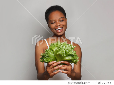 Healthy woman holding vegetable green lettuce on white background. Healthy lifestyle, Vegan 110127933