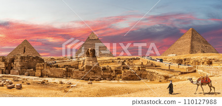 Great Pyramids of Giza and the Sphinx, bedouin with a camel, beautiful panorama of Cairo region, Egypt Great Pyramids of Giza and the Sphinx, bedouin with a camel, beautiful panorama of Cairo region, Egypt 110127988
