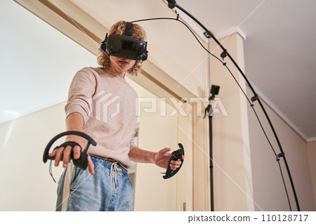 Young active guy in his room Young active guy in his room 110128717