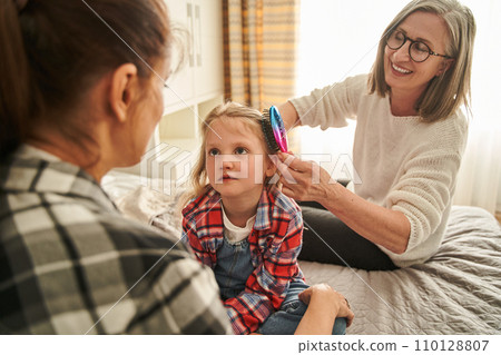 Grandmother, mom and child sitting at the bed and talking in portrait for mothers day Grandmother, mom and child sitting at the bed and talking in portrait for mothers day 110128807