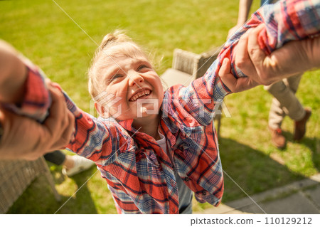 Portrait of cheerful child girl playing with her father in the grassy meadow Portrait of cheerful child girl playing with her father in the grassy meadow 110129212