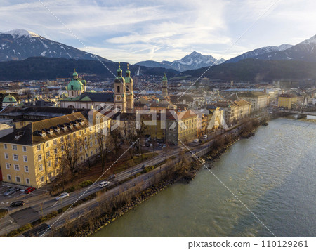 Innsbruck at evening, Aerial Drone Shot of a Beautiful winter City Skyline, Surrounded by Alps Mountains in Austria Innsbruck at evening, Aerial Drone Shot of a Beautiful winter City Skyline, Surrounded by Alps Mountains in Austria 110129261