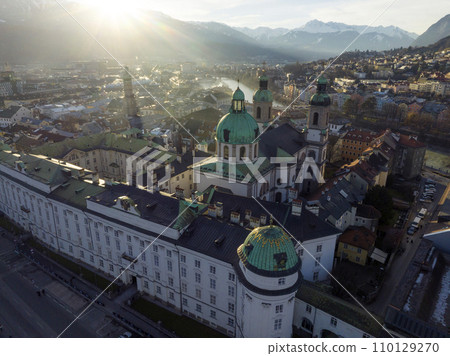 Innsbruck at evening, Aerial Drone Shot of a Beautiful winter City Skyline, Surrounded by Alps Mountains in Austria Innsbruck at evening, Aerial Drone Shot of a Beautiful winter City Skyline, Surrounded by Alps Mountains in Austria 110129270