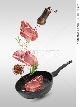 Levitating pieces of pork meat on a rib, spices. Cooking lunch Levitating pieces of pork meat on a rib, spices. Cooking lunch 110129374