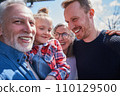 Happy family of three generations posing at camera together 110129500