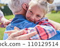 Portrait of cute girl embracing her lovely senior grandfather 110129514