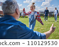 Back view of the mature grandfather spread his arms while meeting little child girl 110129530