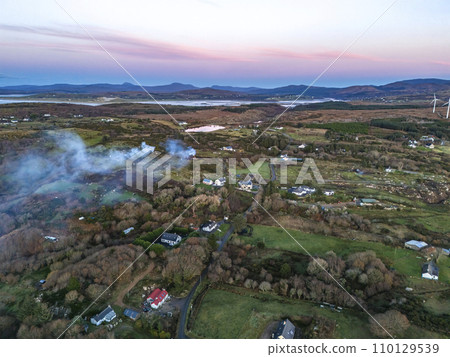 Smoke over Lough Fad due to traditionally burning of waste in rural Ireland - County Donegal 110129539