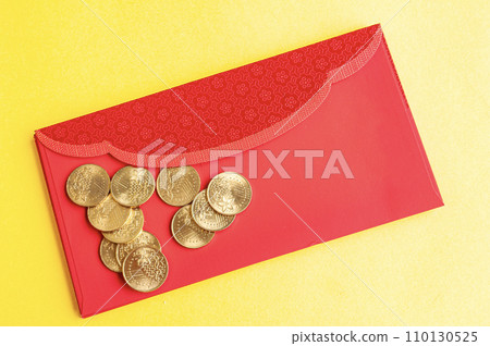 Top view of red envelopes with golden coins on yellow cover with customizable space for text. Top view of red envelopes with golden coins on yellow cover with customizable space for text. 110130525