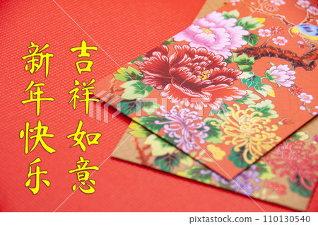 Close up of colorful envelope on red cover background with Chinese New Year wishes 110130540