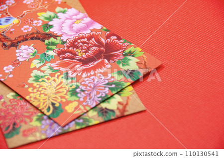 Close up of colorful envelope on red cover background with customizable space for text 110130541