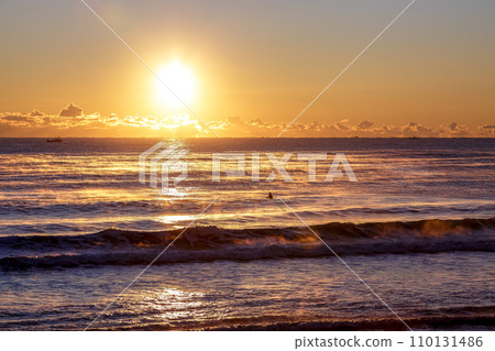 The coast where a red storm appeared due to the light of sunrise [Oarai coast] 110131486