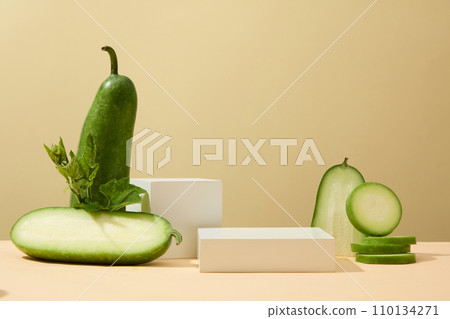 Winter melon cut in half and slices arranged with white pedestals. Winter melon (Benincasa hispida) juice can bring high energy to our body. Organic fruit concept 110134271