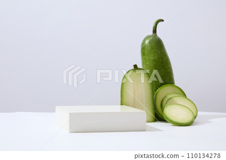 Concept scene stage showcase for new product with winter melon and a podium arranged. Winter melon (Benincasa hispida) has cosmetic uses for the face and hair Concept scene stage showcase for new product with winter melon and a podium arranged. Winter melon (Benincasa hispida) has cosmetic uses for the face and hair 110134278
