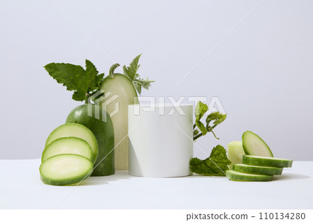 White background featured a cylinder podium white winter melon and green leaves. Studio podium or platform product template mockup of Winter melon (Benincasa hispida) extract White background featured a cylinder podium white winter melon and green leaves. Studio podium or platform product template mockup of Winter melon (Benincasa hispida) extract 110134280