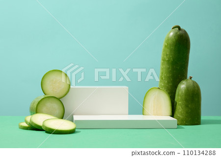 White podiums in rectangle shaped are decorated with fresh winter melon. Winter melon (Benincasa hispida) may promote a healthy body weight White podiums in rectangle shaped are decorated with fresh winter melon. Winter melon (Benincasa hispida) may promote a healthy body weight 110134288