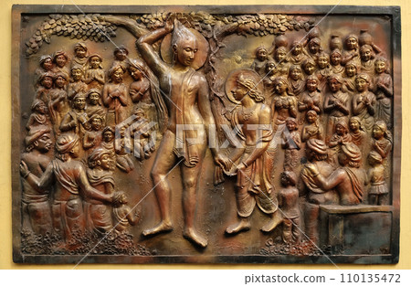 Plucking off the hair with his own hands and accepting the vow of renunciation, Street bass relief on the wall of Jain Temple (also called Parshwanath Temple) in Kolkata, West Bengal, India Plucking off the hair with his own hands and accepting the vow of renunciation, Street bass relief on the wall of Jain Temple (also called Parshwanath Temple) in Kolkata, West Bengal, India 110135472