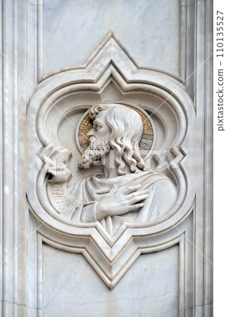 Saint, relief on the facade of Basilica of Santa Croce (Basilica of the Holy Cross) - famous Franciscan church in Florence, Italy 110135527