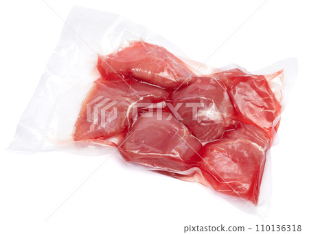 close-up Vacuum packed tuna fillet pieces in transparent plastic for preserving the freshness isolated on white background 110136318