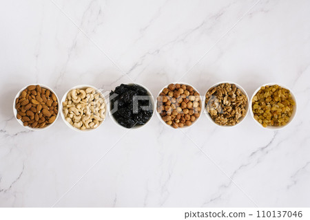 Various nuts and dried fruits in white bowl Various nuts and dried fruits in white bowl 110137046